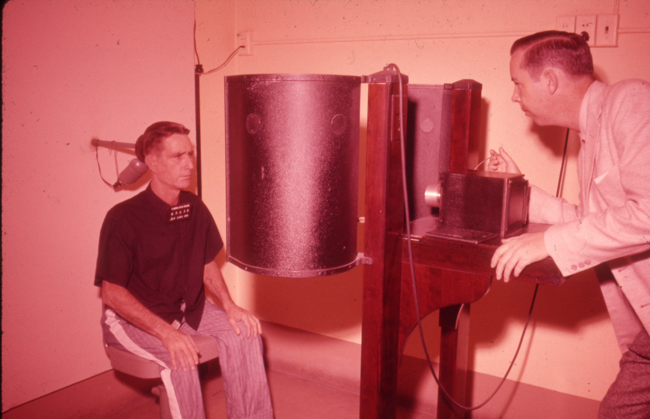 Slide 1: A picture of a prisoner having his photo taken